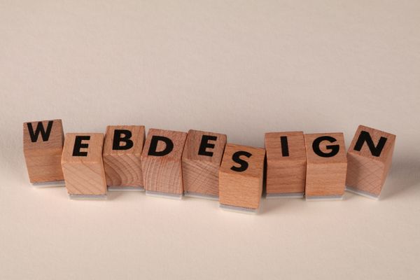 Wooden blocks spelling web design, representing design thinking